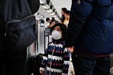 A child wears a medical mask out of concern over the Coronavirus at the JFK terminal that serves planes bound for China.