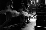 Ballerinas in tutus waiting off stage for their entrance