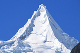 Mt. Alpamayo, Peru (19,511 ft, 5,947 m). Photo by Frank R 1981, on Wikipedia.