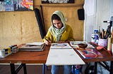 A 24-year-old artist and designer Zahra works in her office in Kabul.