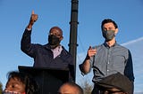 Democratic U.S. Senate candidates Jon Ossoff and Raphael Warnock wearing face masks.