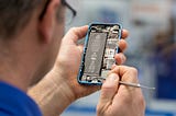 A man repairing an open smartphone