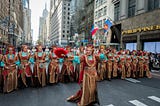 Dancers wearing Spanish costumes marching down 5th Avenue in New York for Hispanic Heritage Month.