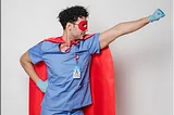 Male nurse dressed in superhero cape and mask