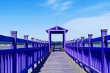 A part of the long bridge with purple wooden sides.