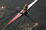 A woman rowing a kayak.