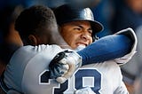 NY Yankees teammates Gleyber Torres and Cameron Maybin hug as they celebrate a two run home run against the Toronto Blue Jays