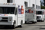 FedEx trucks lined up on a street