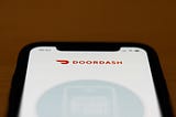 The Doordash app logo is seen on an iPhone screen.