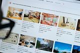In this photo illustration, a man looks at listings on the Airbnb website.