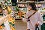 A woman masked up at the grocery store.