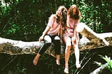 Two young girls in the woods