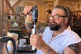 Guy using a drill to grind coffee.