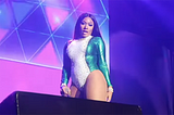 Megan Thee Stallion on stage singing and showing off her body