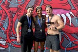 Photo of Sam Surridge, Dame Kelly Holmes, and Rico Surridge on the finish line of the London 2023 Spartan Super Obsticle Race.