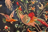 Colorful birds and flowers embroidered on black silk.