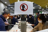 A photo of a sign that prohibits not wearing a face mask at a South Korean cafeteria.