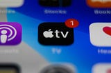 Apple TV icon on a phone with a notification badge.