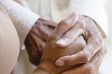 A photo of someone holding another’s hands.