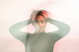 Photo of a woman looking frustrated with both hands on the side of her head