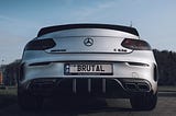 Image of a mercedes with a vanity license plate that reads “brutal”