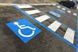 Close up of handlcapped symbol in a parking place.