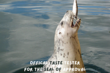Photo of a seal (labeled “official taste tester for the Seal of Approval) lunging up out of the water to scarf down a fish being dangled by a long-haired person barely shown at right.