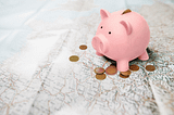 Roadmap under a piggy savings bank, change is scattered