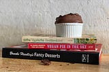 Ramekin of chocolate mousse on top of The Farm Vegetarian Cookbook, Vegan Pie in the Sky, Brooks Headley’s Fancy Desserts