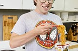 Photo of Justin Warner eating a bowl of noodles.