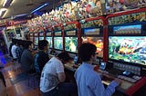 People playing Street Fighter 4 in an Arcade