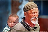 A child being carried by an old man in Eastern Qazaqstan.