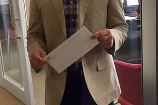 Man with a white envelope for “Resignations Suck” article