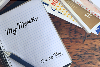 memoir notebook beside stack of memoirs
