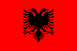 The flag of Albania, a two headed black eagle on a red background.