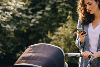 Woman Checking Messages On Her Smart Phone While Pushing An Infant Stroller by Jacob Lund Photography from NounProject.com