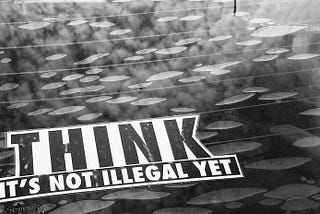 stenciled words “Think, it’s not illegal yet”