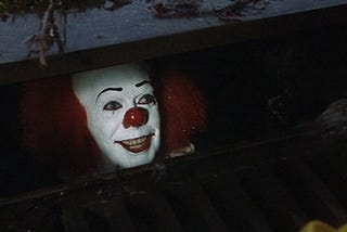 Pennywise stares from a sewer