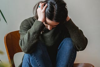 woman sitting looking exhausted