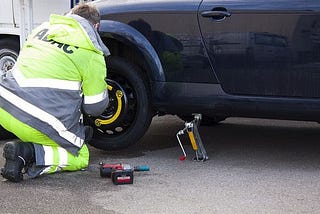 A man changing his flat tire