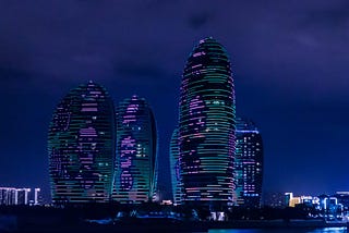 Modern building light up in blue neon lights to show metaverse real estate