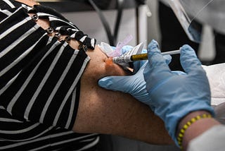A participant in a Covid-19 vaccine trial receives a dose of the vaccination in Hollywood, Florida…