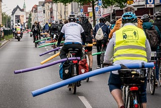 Cyclists with pool noodles signalling cars must give 1.5m of passing space