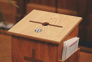 A Tithe/Offering box on a table in a church