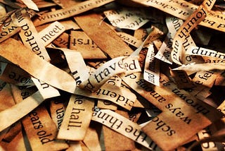 close-up view of a pile of words and phrases hand-cut from vintage book pages by author