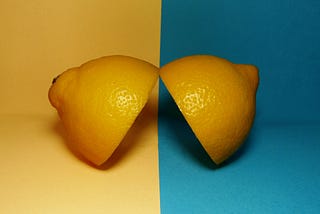 Two halves of a lemon on various backgrounds signal a duality