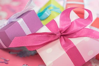 Photo of presents wrapped in pastel paper and bows.