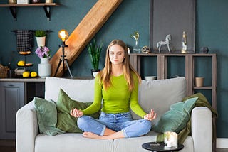 Girl on sofa meditating