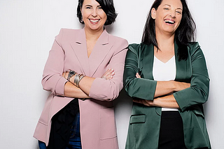 Image of founders Belinda and Crystal laughing with arms folded.