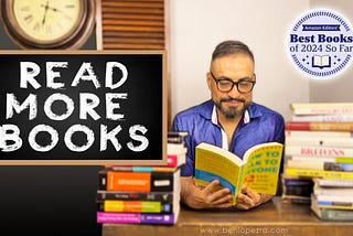 Man wearing glasses reading a book titled ‘How to Talk to Anyone,’ sitting next to a stack of books with a chalkboard displaying the words ‘READ MORE BOOKS.’ The image also features a badge that says ‘Amazon Editors’ Best Books of 2024 So Far.